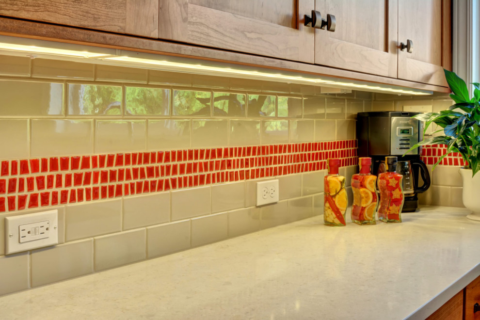 Small l-shaped medium tone wood floor and brown floor eat-in kitchen photo in Seattle with an undermount sink, shaker cabinets, medium tone wood cabinets, red backsplash, mosaic tile backsplash, stainless steel appliances, an island and white countertops