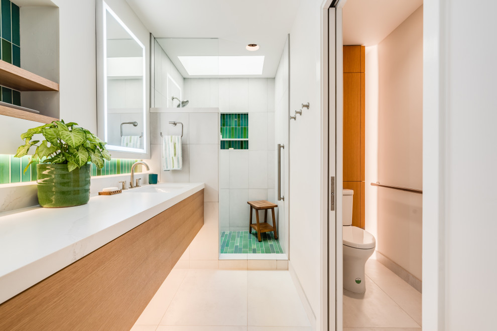 Inspiration for a medium sized contemporary ensuite bathroom in Sacramento with flat-panel cabinets, light wood cabinets, an alcove shower, a one-piece toilet, white tiles, white walls, a submerged sink, engineered stone worktops, a hinged door, white worktops, an enclosed toilet, a single sink and a built in vanity unit.