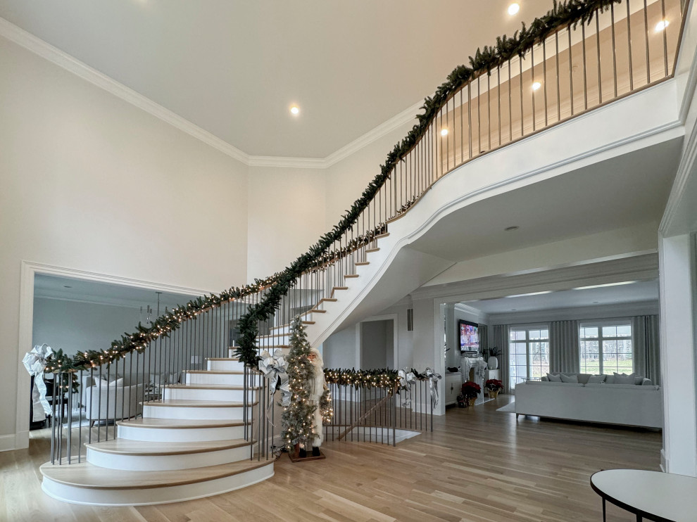 Design ideas for a large classic wood floating mixed railing staircase in DC Metro with painted wood risers.