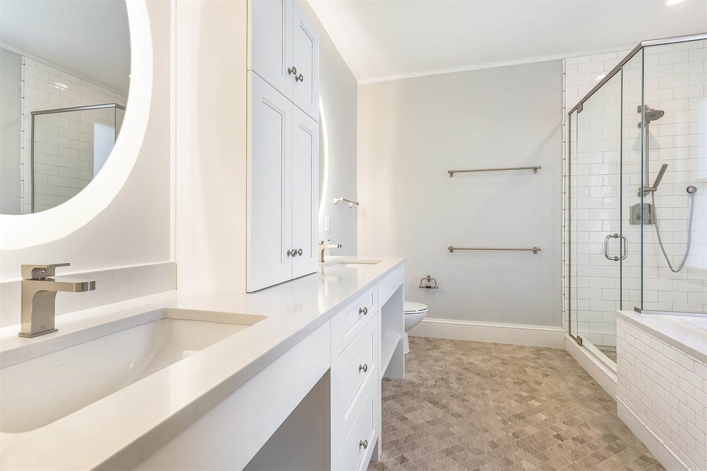 Design ideas for a large transitional master bathroom in Seattle with recessed-panel cabinets, white cabinets, a drop-in tub, a corner shower, a two-piece toilet, white tile, ceramic tile, grey walls, ceramic floors, an undermount sink and engineered quartz benchtops.