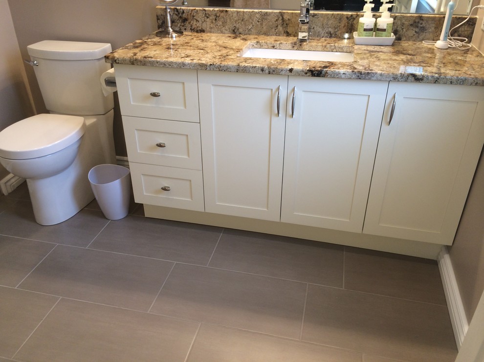 Small contemporary 3/4 bathroom in Ottawa with shaker cabinets, an alcove shower, a two-piece toilet, white cabinets, gray tile, multi-coloured tile, matchstick tile, grey walls, ceramic floors, an undermount sink, granite benchtops, grey floor, a hinged shower door and multi-coloured benchtops.
