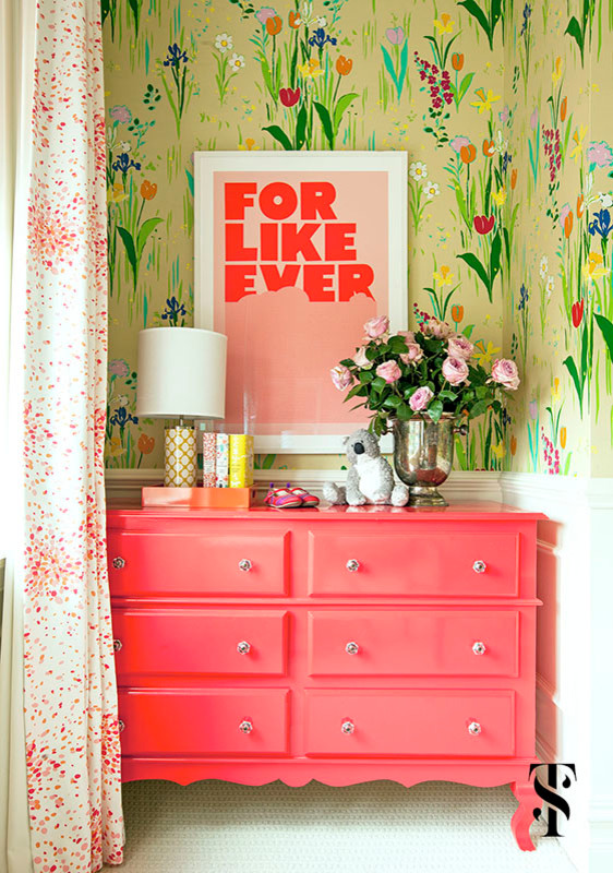 Lincoln Park Vintage Featured in Domino & House Beautiful - 
Pink and green abound in this bedroom. Graphic floral wallpaper is complemented by pink and white draperies with striped roman shades. A daybed along one wall allows room for a play table with pops of teal and a sitting area. 
Open shelving and a coral dresser provide space for books, toys and keepsakes. 

Summer Thornton Design, Inc.