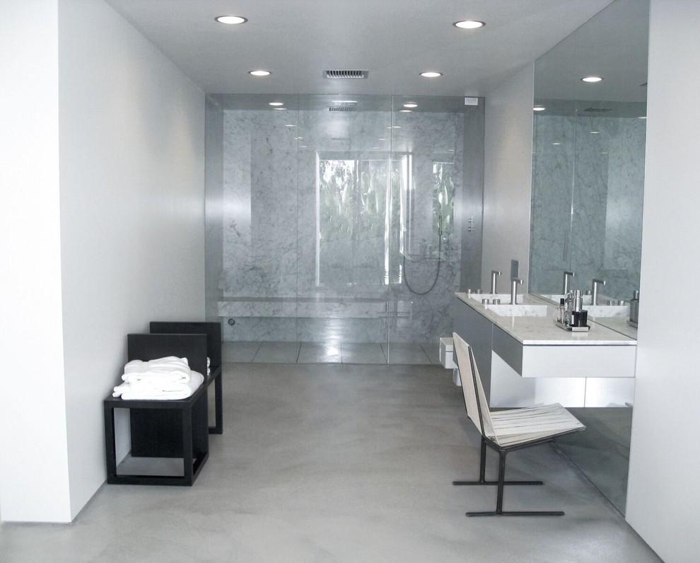 This is an example of a large midcentury master bathroom in Los Angeles with flat-panel cabinets, grey cabinets, a curbless shower, white walls, concrete floors, an integrated sink, marble benchtops, a wall-mount toilet, grey floor and a hinged shower door.