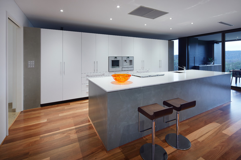 This is an example of a mid-sized contemporary galley open plan kitchen in Perth with with island.