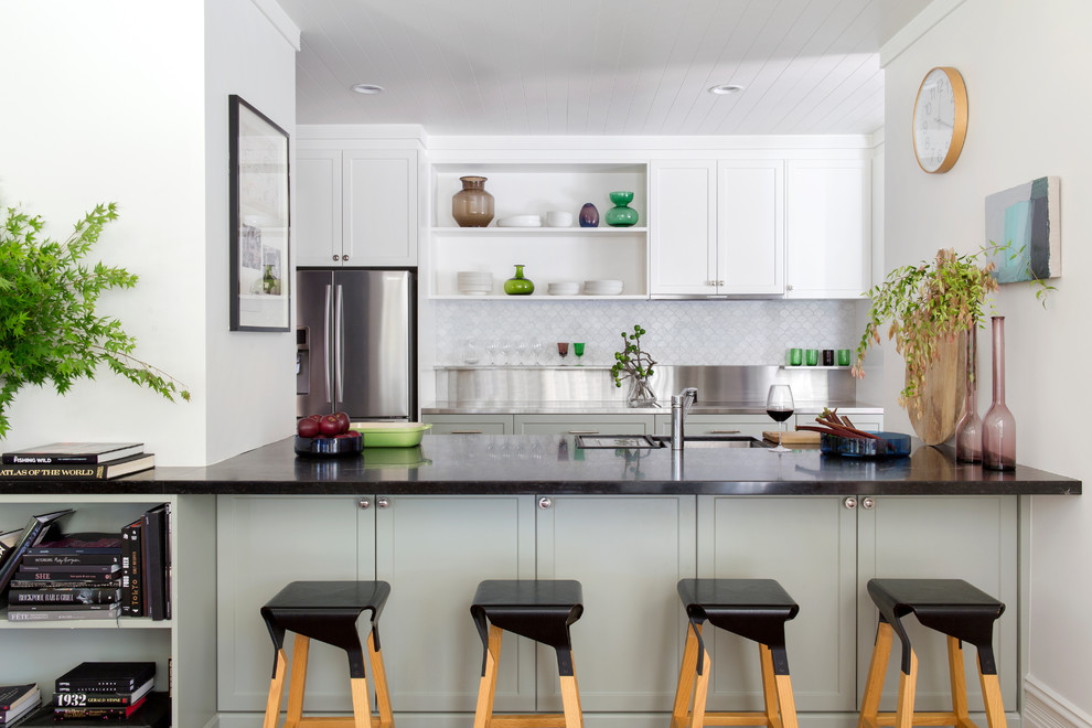 Inspiration for a transitional u-shaped kitchen in Perth with shaker cabinets, stainless steel benchtops, an undermount sink, grey cabinets, grey splashback, stainless steel appliances, no island and black benchtop.