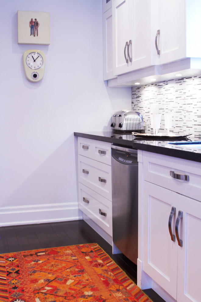 Enclosed kitchen - mid-sized transitional galley dark wood floor enclosed kitchen idea in Toronto with shaker cabinets, white cabinets, granite countertops, multicolored backsplash, stainless steel appliances, a double-bowl sink and matchstick tile backsplash