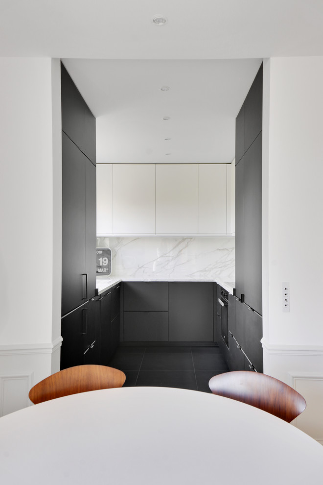 Photo of a small contemporary u-shaped open plan kitchen in Paris with an integrated sink, flat-panel cabinets, black cabinets, marble benchtops, white splashback, panelled appliances, ceramic floors, black floor, white benchtop and no island.