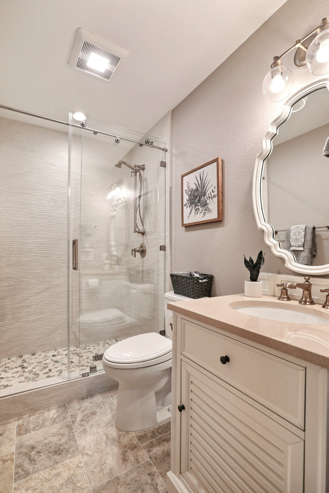 Alcove shower - mid-sized transitional 3/4 ceramic tile and beige tile porcelain tile, beige floor and single-sink alcove shower idea in San Francisco with louvered cabinets, an undermount sink, beige countertops, beige cabinets, a two-piece toilet, gray walls and a built-in vanity