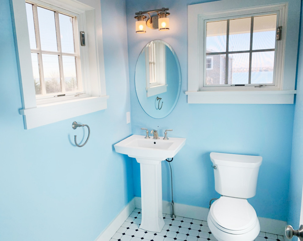 Design ideas for a small beach style bathroom in Providence with a two-piece toilet, blue walls, porcelain floors, a pedestal sink, multi-coloured floor and a single vanity.