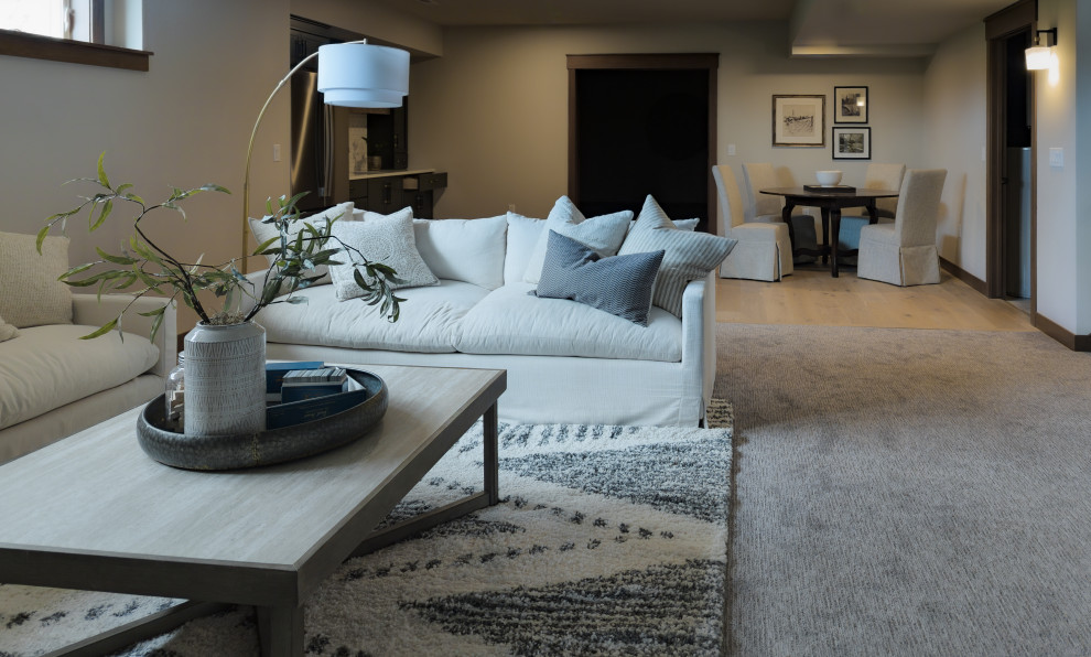 Basement - transitional look-out carpeted and gray floor basement idea with a bar