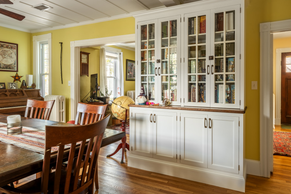 Mid-sized arts and crafts kitchen/dining combo in Boston with yellow walls and coffered.