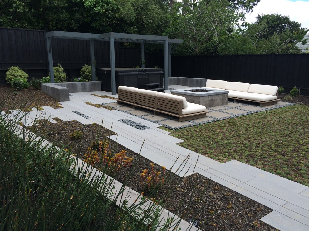 Inspiration for a large contemporary backyard garden in San Francisco with a fire feature and concrete pavers.