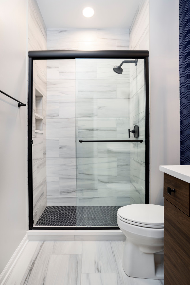 Design ideas for a contemporary 3/4 bathroom in Chicago with medium wood cabinets, an alcove shower, a two-piece toilet, porcelain tile, white walls, mosaic tile floors, engineered quartz benchtops, black floor, a sliding shower screen, white benchtops, a niche, a single vanity, gray tile and an undermount sink.