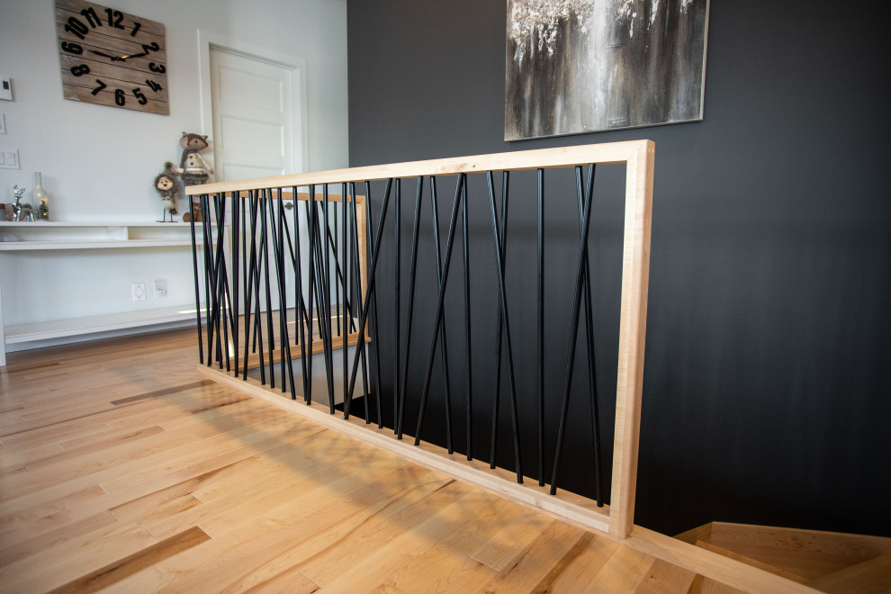 This is an example of a contemporary wood l-shaped staircase in Montreal with wood risers and mixed railing.
