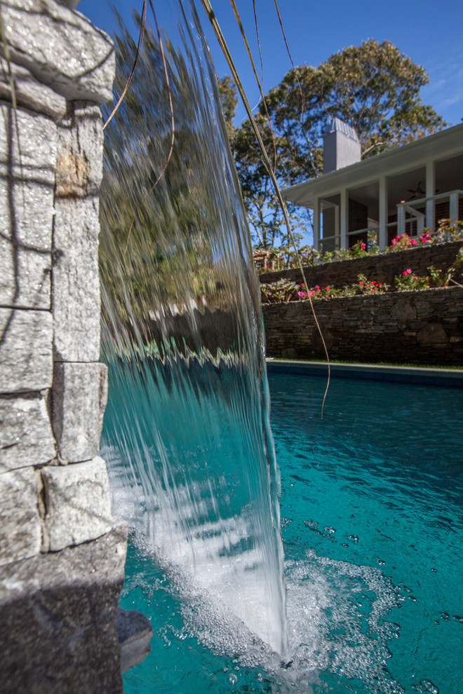 Inspiration for a huge transitional backyard concrete paver and rectangular lap pool fountain remodel