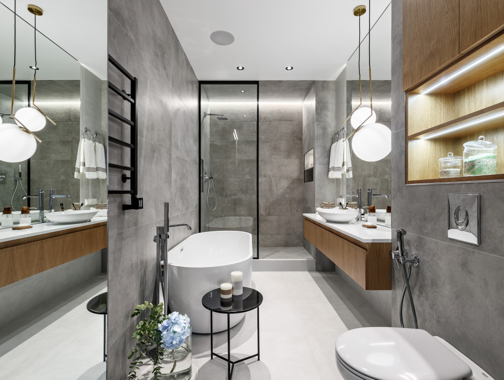 Inspiration for a contemporary master bathroom in Saint Petersburg with flat-panel cabinets, medium wood cabinets, a freestanding tub, an alcove shower, a vessel sink, grey floor, white benchtops, a single vanity and a floating vanity.