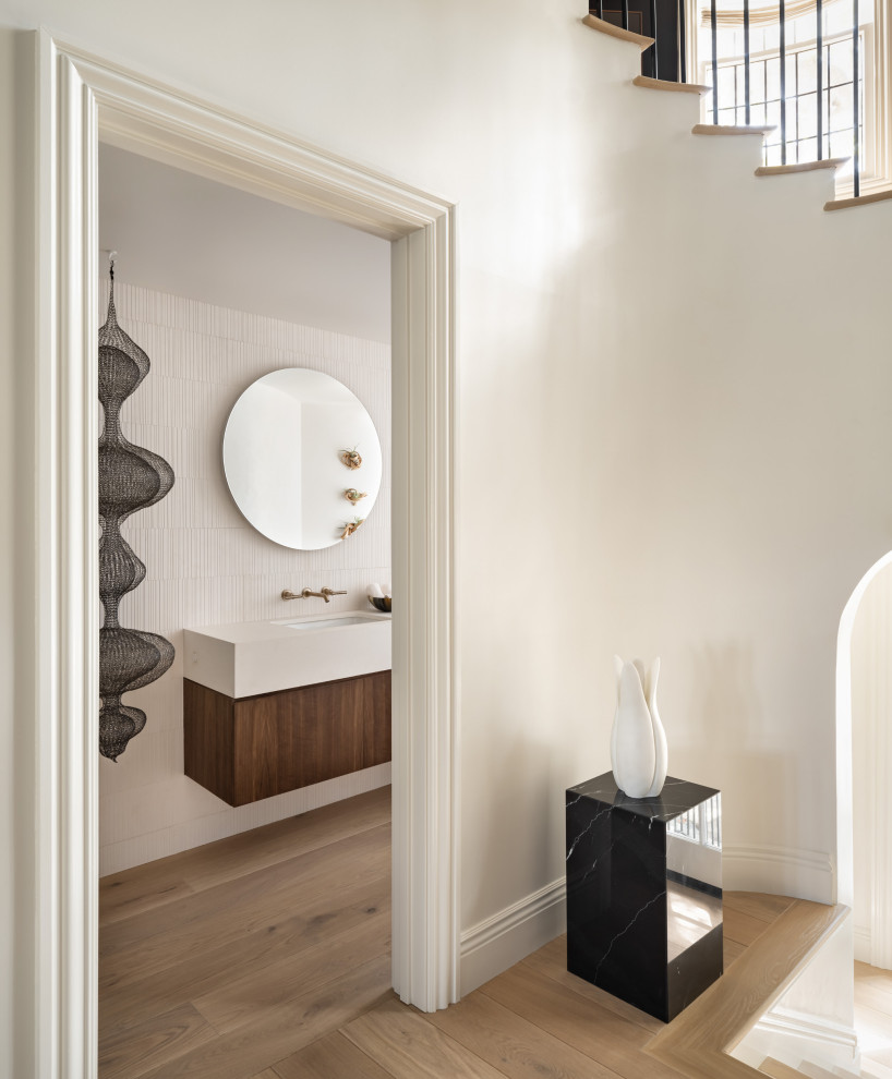 Small danish medium tone wood floor and brown floor powder room photo in San Francisco with dark wood cabinets and a built-in vanity