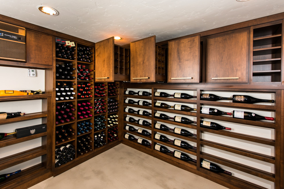Mid-sized modern wine cellar in Other with concrete floors, display racks and beige floor.