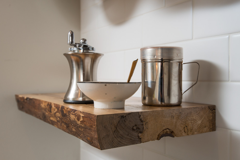 Inspiration for a mid-sized transitional l-shaped eat-in kitchen remodel in Boston with recessed-panel cabinets, green cabinets, soapstone countertops, white backsplash, subway tile backsplash, stainless steel appliances and a peninsula