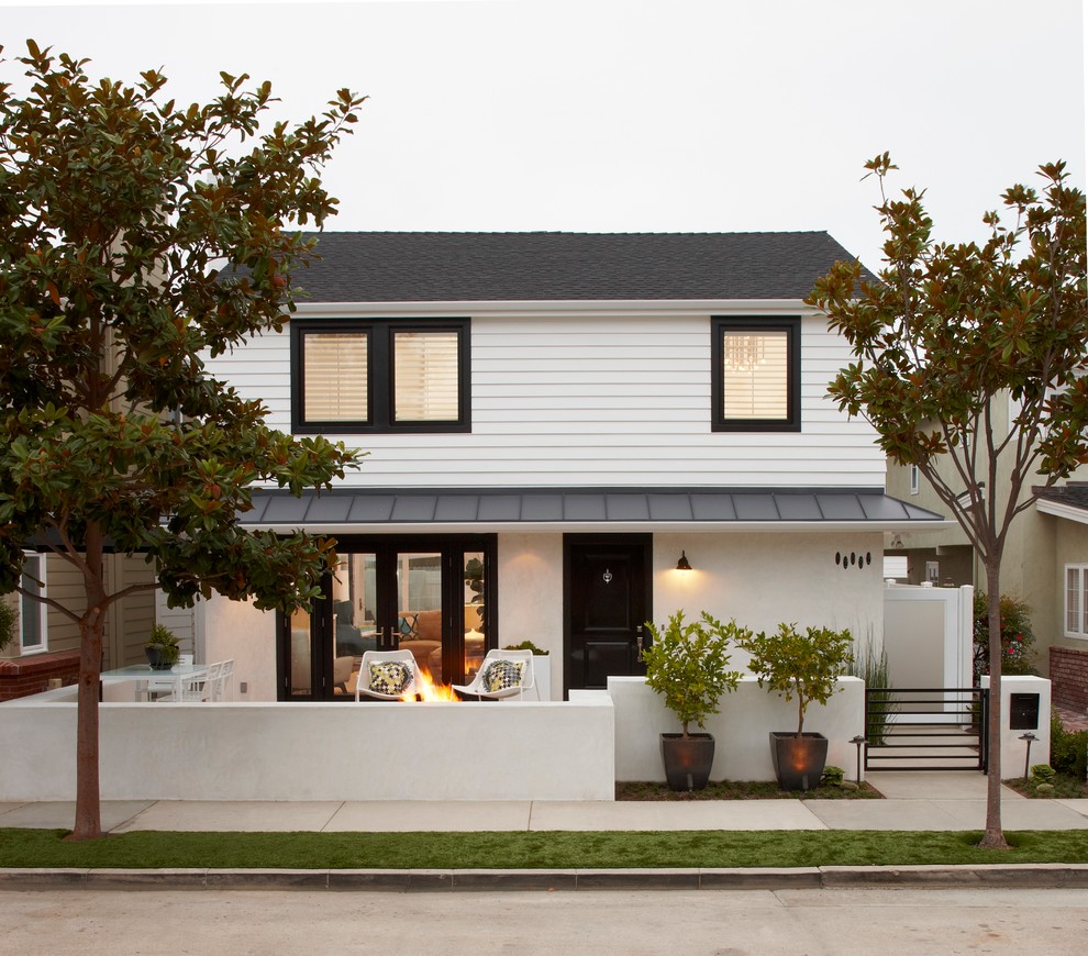 This is an example of a transitional two-storey exterior in Orange County with a mixed roof.