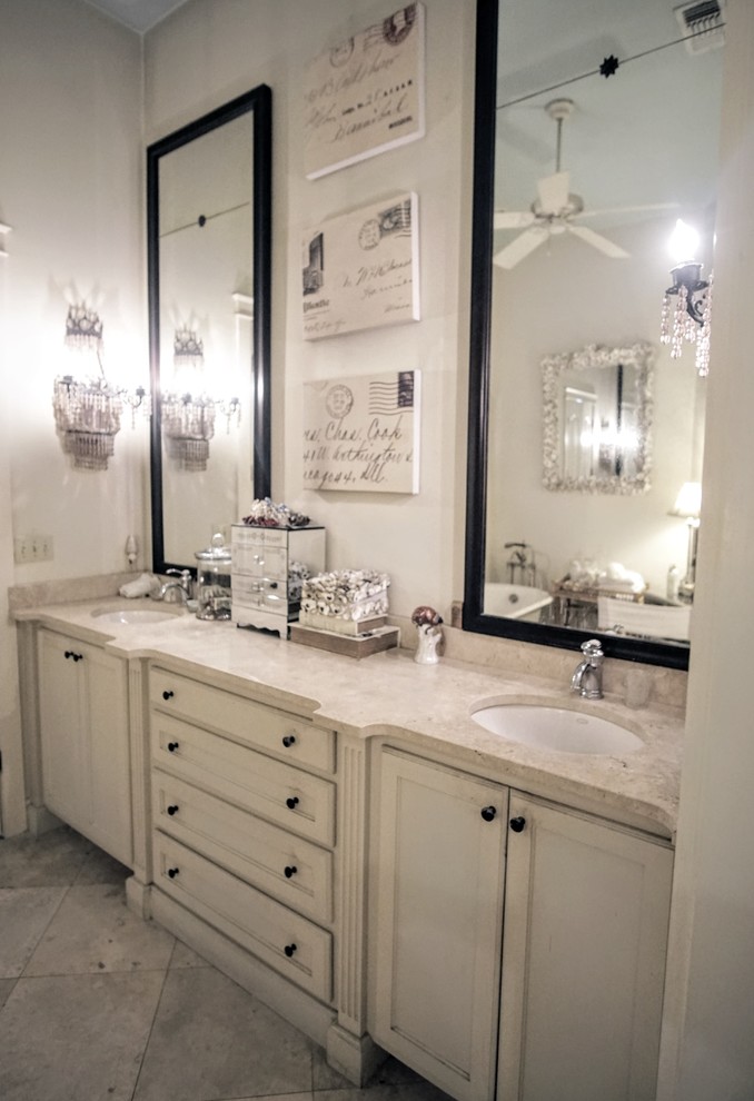 Inspiration for a large country master bathroom in Miami with raised-panel cabinets, beige cabinets, a claw-foot tub, a curbless shower, a one-piece toilet, beige tile, limestone, white walls, limestone floors, an undermount sink, granite benchtops, beige floor, a hinged shower door and beige benchtops.