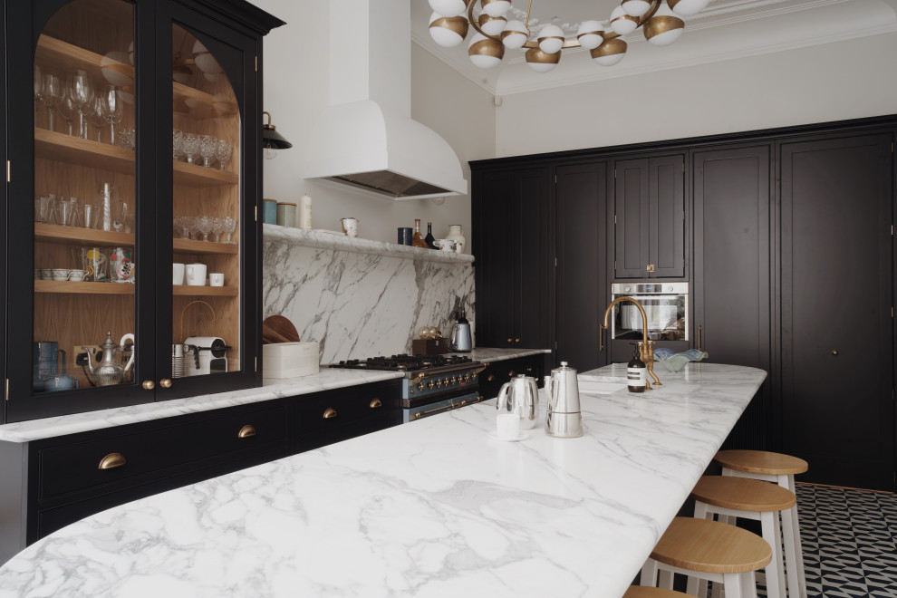 Design ideas for a mid-sized transitional galley eat-in kitchen in London with a farmhouse sink, shaker cabinets, black cabinets, marble benchtops, white splashback, marble splashback, black appliances, porcelain floors, with island, blue floor, white benchtop and vaulted.