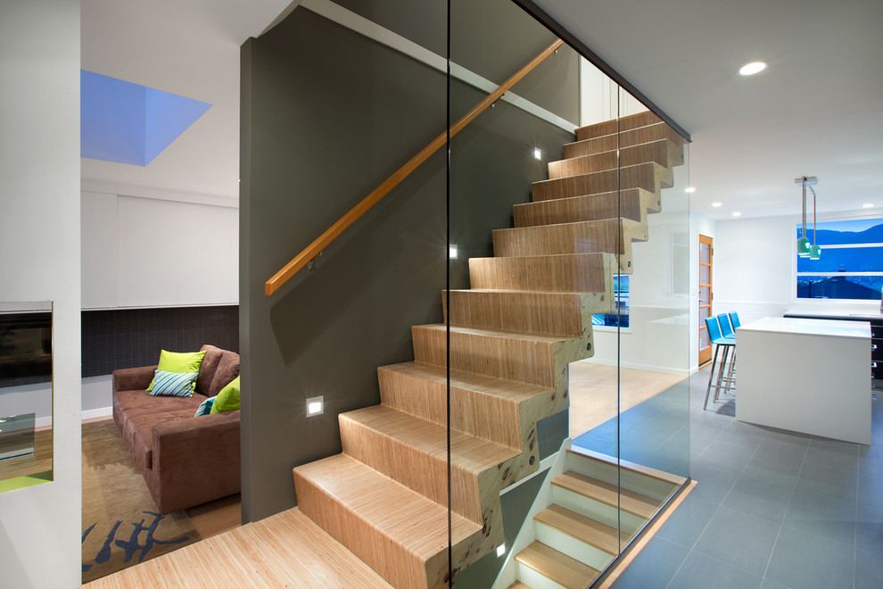 Design ideas for a contemporary wood straight staircase in Vancouver with wood risers.