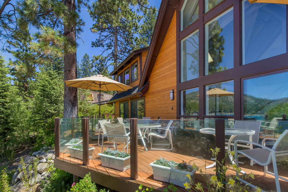 Example of a large mountain style backyard deck design with no cover