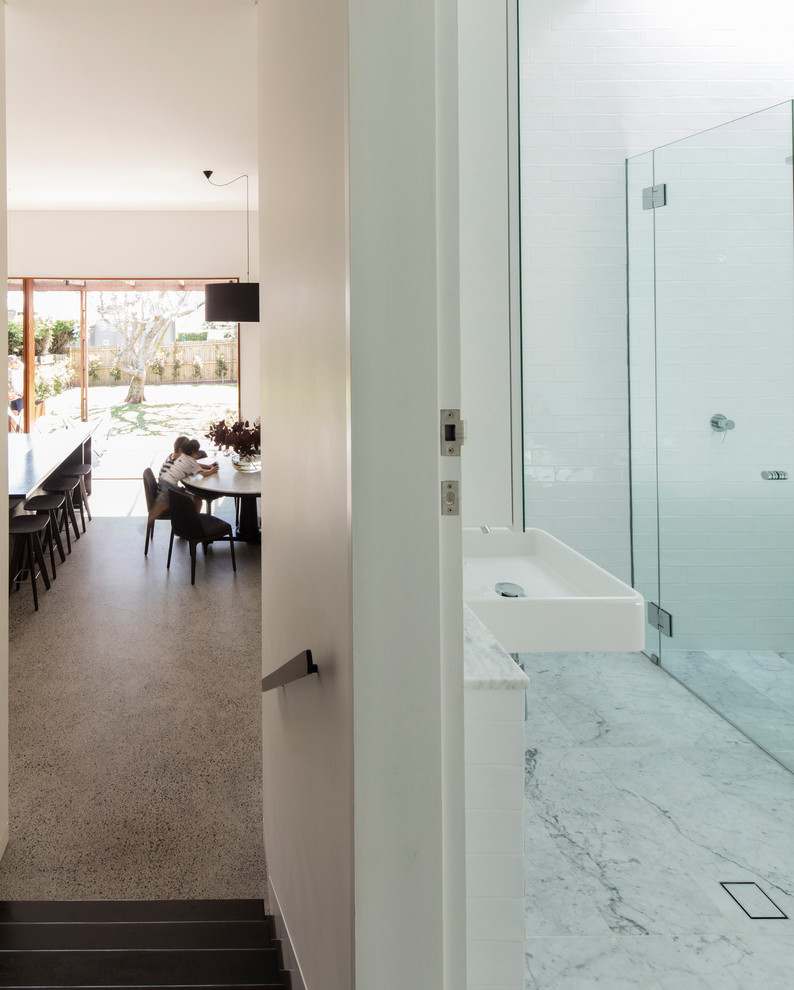 Contemporary bathroom in Sydney with white tile and white floor.