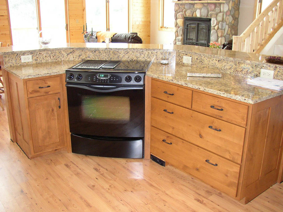 Open concept kitchen - large rustic l-shaped light wood floor and brown floor open concept kitchen idea with an undermount sink, shaker cabinets, medium tone wood cabinets, stainless steel appliances, an island and granite countertops