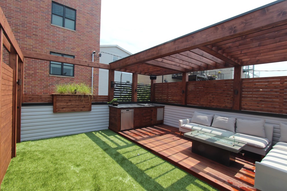 Inspiration for a mid-sized modern rooftop deck in Chicago with an outdoor kitchen and a pergola.
