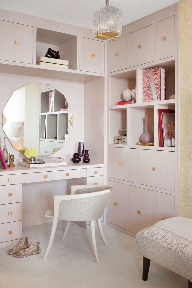This is an example of a mid-sized contemporary women's dressing room in New York with flat-panel cabinets.