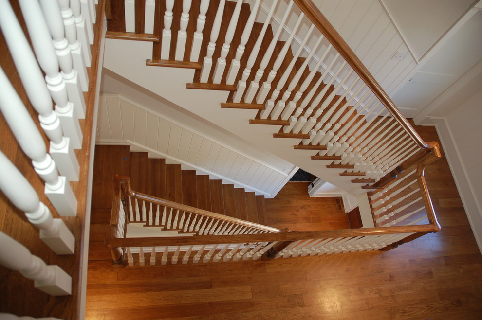 Photo of a mid-sized traditional wood curved staircase in Philadelphia with painted wood risers and wood railing.