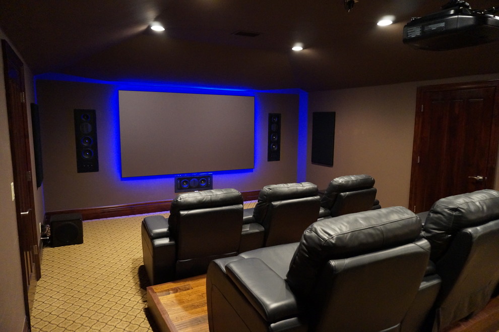 Mid-sized transitional enclosed home theatre in Austin with brown walls, carpet and a projector screen.