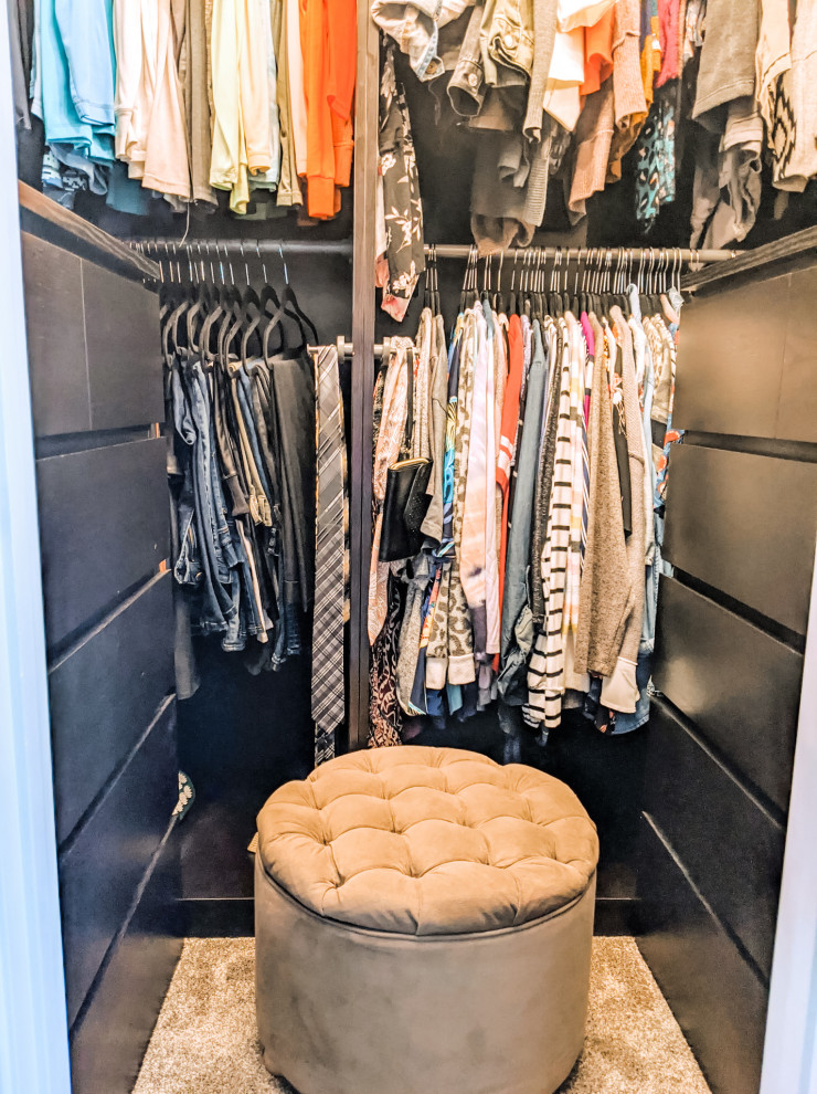 Design ideas for a small traditional gender-neutral walk-in wardrobe in Kansas City with open cabinets, dark wood cabinets, carpet and grey floor.