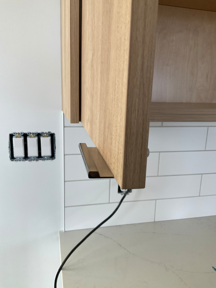 Modern prefab kitchen with light wood cabinets and white finishes