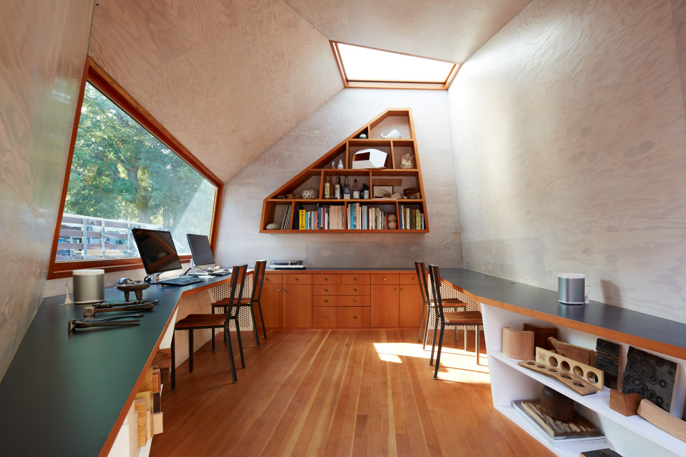 Diseño de despacho abovedado contemporáneo pequeño con suelo de madera clara, escritorio empotrado y madera