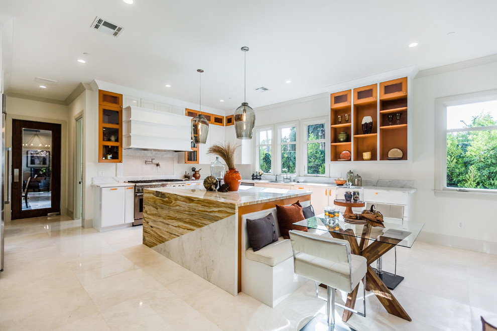 Inspiration for a contemporary l-shaped kitchen in Los Angeles with an undermount sink, flat-panel cabinets, orange cabinets, stainless steel appliances, with island, beige floor and multi-coloured benchtop.