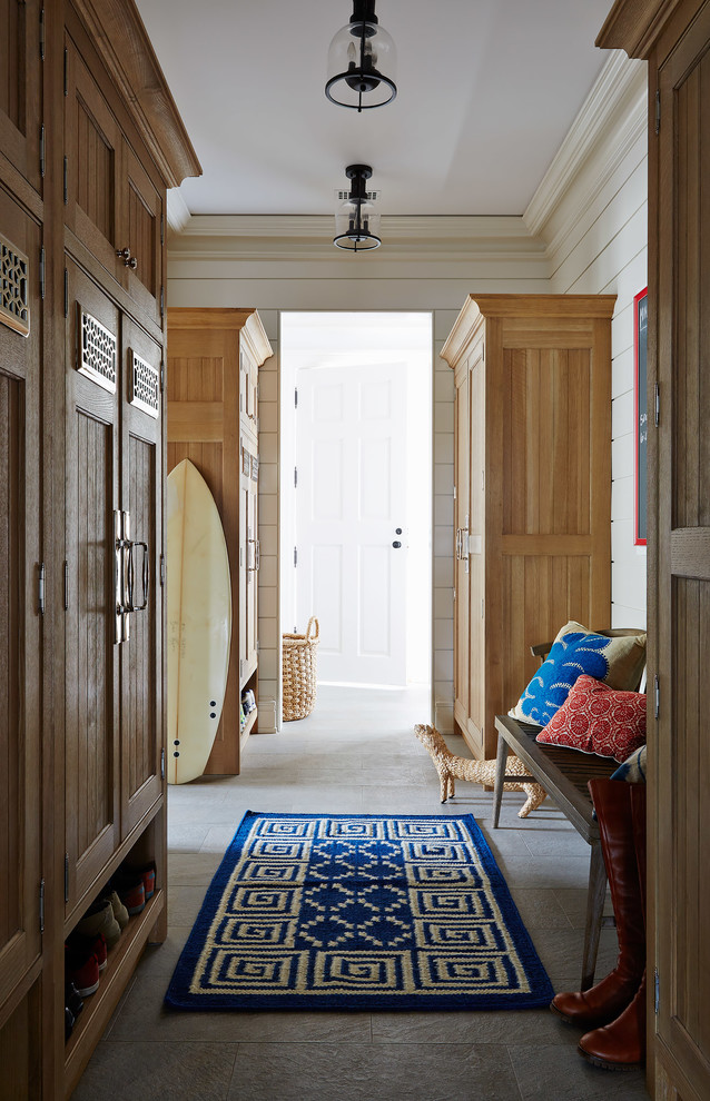 Inspiration for a large coastal gray floor mudroom remodel in Jacksonville with beige walls