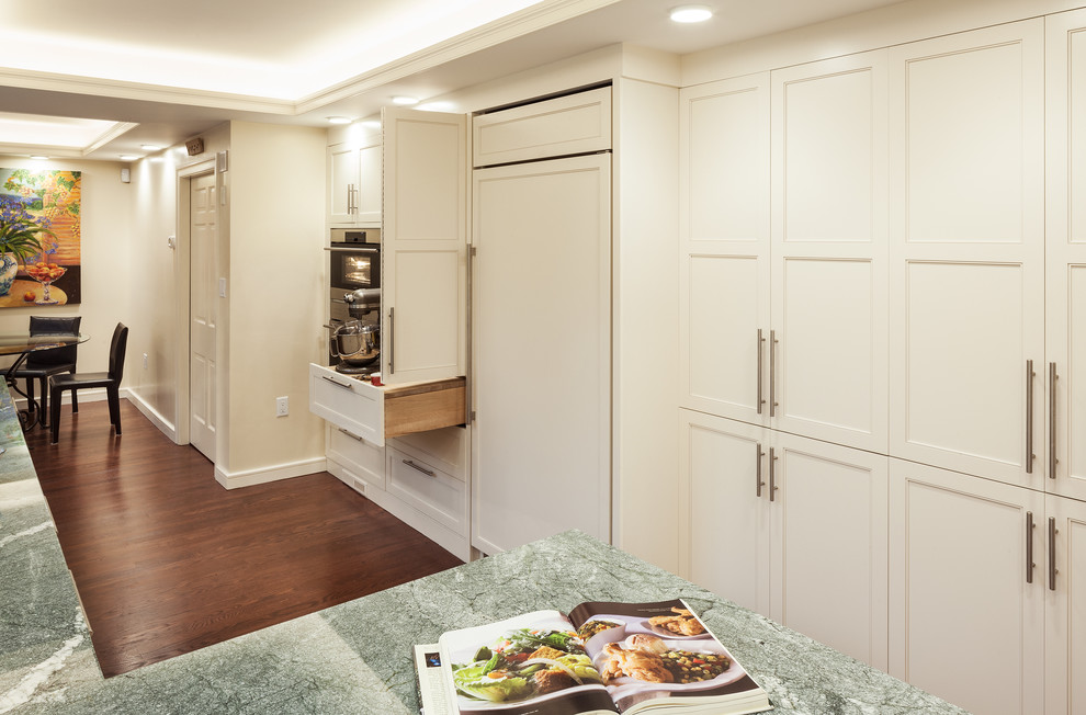 Example of a large transitional galley medium tone wood floor open concept kitchen design in Boston with an undermount sink, shaker cabinets, white cabinets, granite countertops, multicolored backsplash, stone slab backsplash, stainless steel appliances and a peninsula