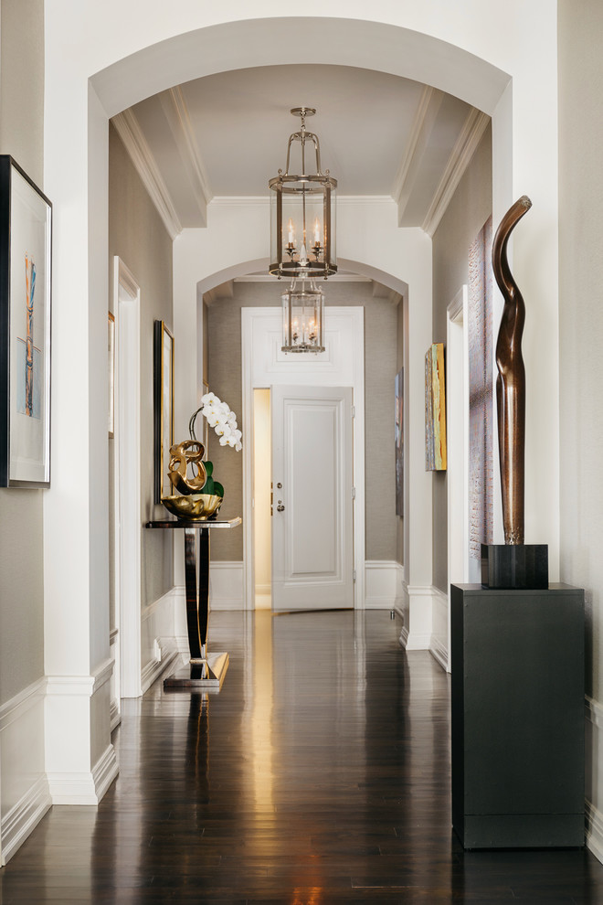 Photo of a mid-sized contemporary entry hall in San Francisco with beige walls, dark hardwood floors, a white front door and brown floor.