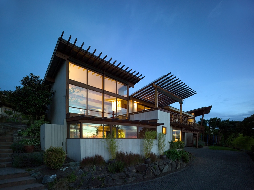 Photo of a large modern two-storey grey house exterior in Seattle with wood siding and a flat roof.