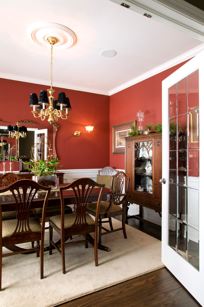Design ideas for a traditional dining room in Toronto with red walls and dark hardwood floors.