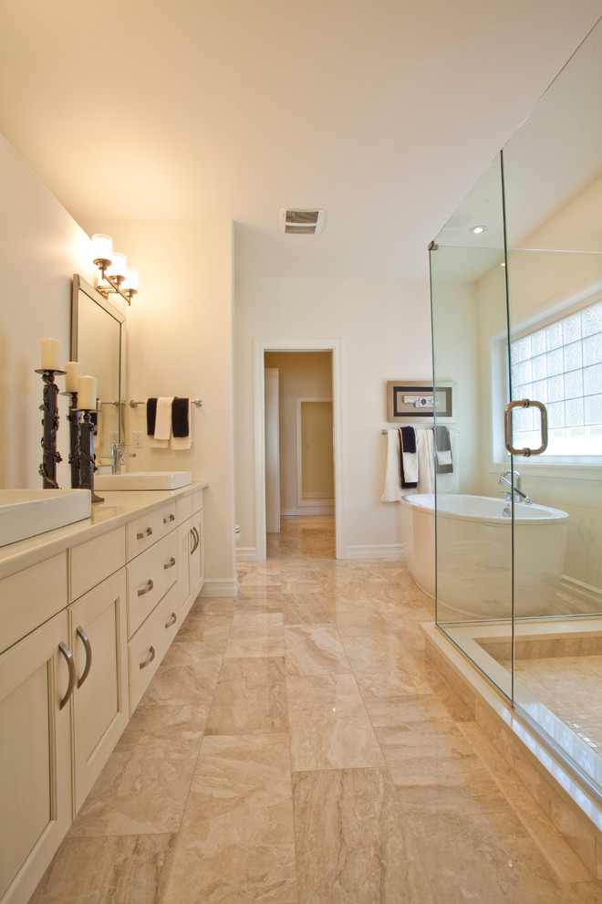 Example of a large transitional master porcelain tile freestanding bathtub design in Calgary with beaded inset cabinets, beige cabinets, white walls and a vessel sink