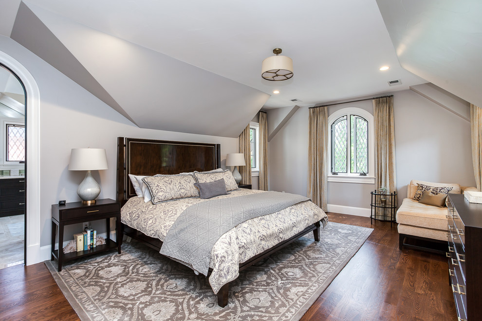 This is an example of a transitional bedroom in Denver with grey walls and dark hardwood floors.