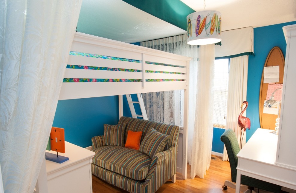 Photo of a small tropical kids' bedroom for kids 4-10 years old and girls in DC Metro with blue walls, light hardwood floors and brown floor.