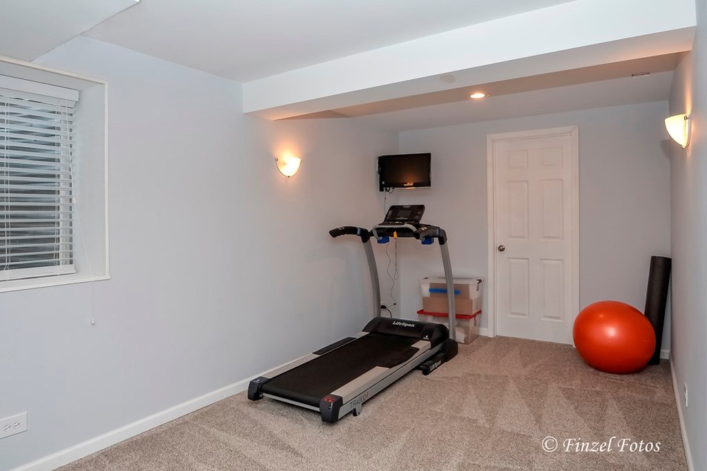 Inspiration for a mid-sized traditional home gym in Chicago with grey walls, carpet and beige floor.