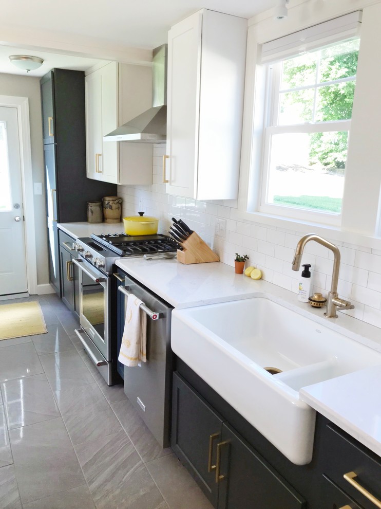 Kitchen - transitional gray floor kitchen idea with a farmhouse sink, quartz countertops and stainless steel appliances