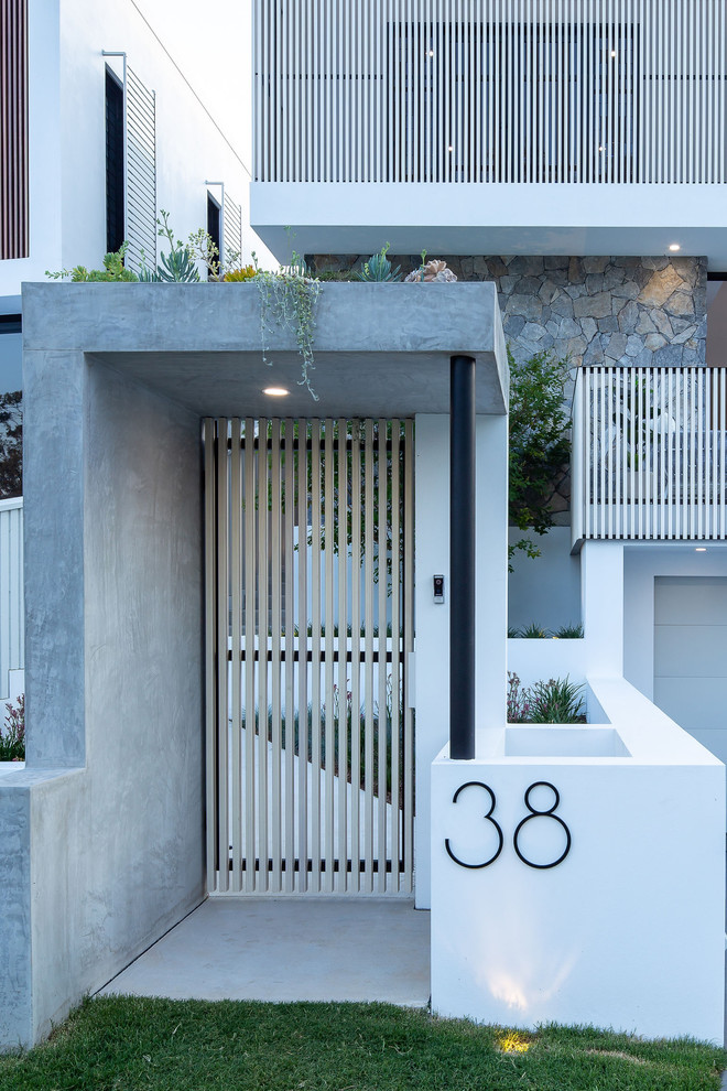 Small contemporary entryway in Brisbane with white walls, concrete floors and grey floor.