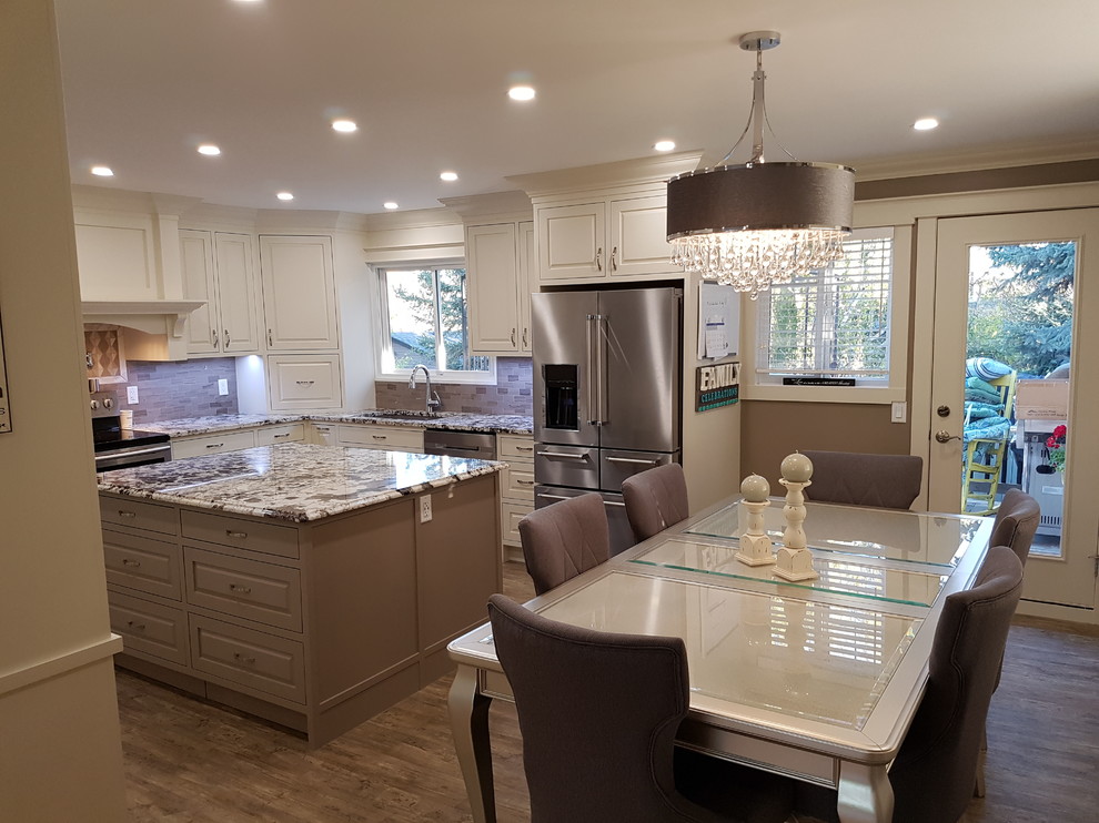 Mid-sized transitional u-shaped vinyl floor and gray floor eat-in kitchen photo in Calgary with an undermount sink, beaded inset cabinets, white cabinets, granite countertops, gray backsplash, stainless steel appliances, two islands, gray countertops and ceramic backsplash